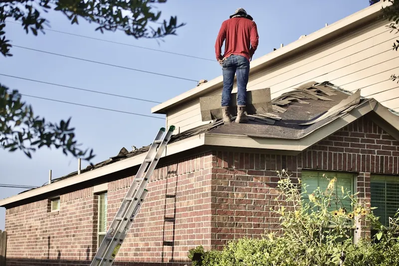 Professional roofer working on a residential roof in Anderosa